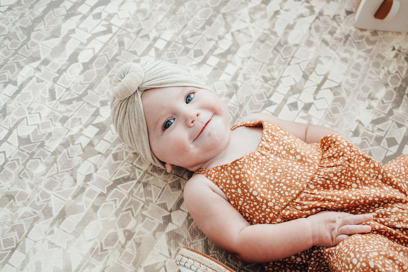 Cute baby laying on stylish baby foam play mat by Famokids